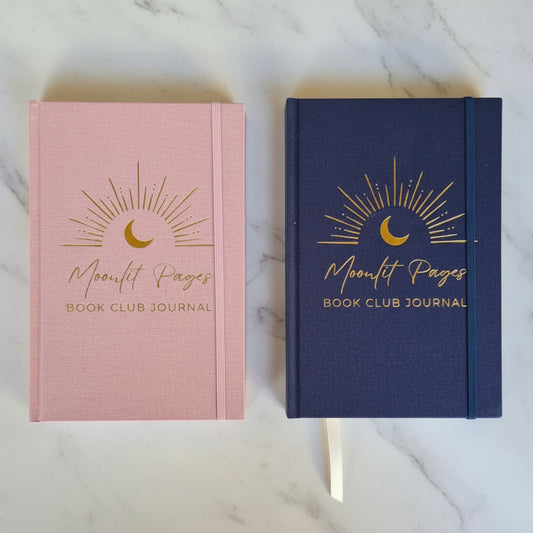 Moonlit Pages Book Club Journal in navy Night edition and pink Day edition side by side