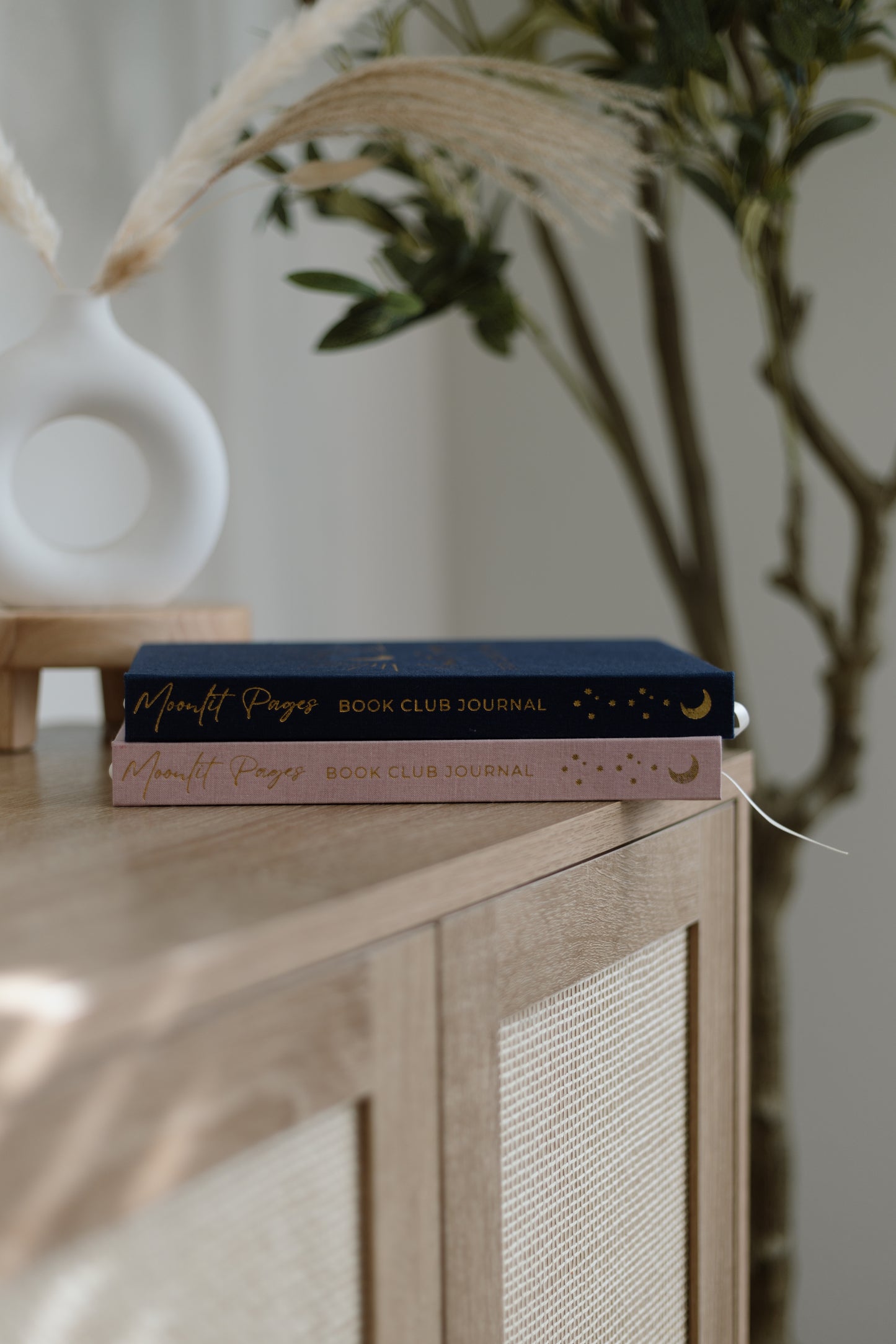 Moonlit Pages Book Club Journal Day and Night editions stacked — pink and navy hardcover reading journals